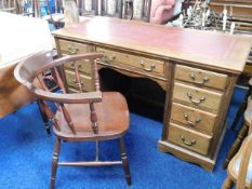 A vintage desk with mahogany veneer twinned with a