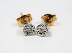 A pair of illusion set 9ct gold diamond stud earri