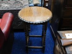 An oak occasional table with pie crust edge & barl