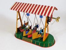 A J.W. Germany tinplate clockwork fairground ride