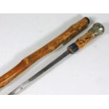 A knotty wood walking stick with concealed sword