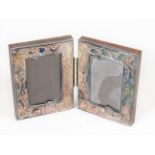 A small double silver photo frame mounted in woode