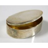 A small silver pill box with gilt lining