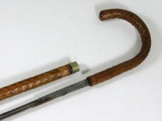 A traditionally shaped walking cane with concealed