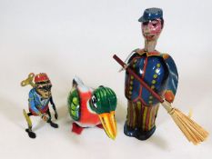 Three tinplate toys, two of which are clockwork