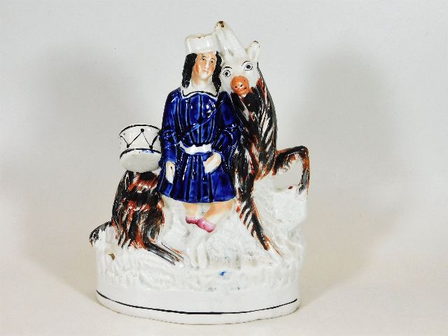A 19thC. Staffordshire figure depicting drummer bo