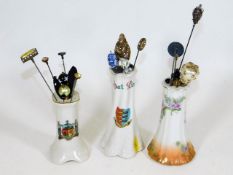 Three porcelain hat pin stands with contents