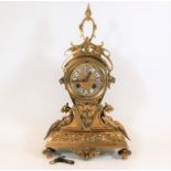 A gilt bronze mantel clock with key