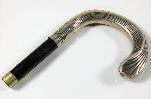 A decorative French silver cane handle