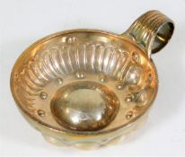A French silver tastevin with scrolled handle
