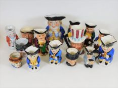 A collection of 15 small character jugs including