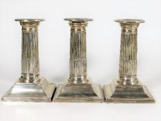 Three silver corinthian column style candlesticks