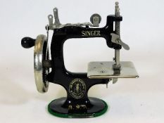 A miniature Singer sewing machine 6.5in tall