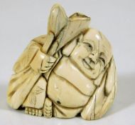 A c.1900 Japanese carved ivory netsuke of a Buddha