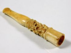 An early 20thC. Chinese carved ivory cheroot featu