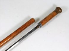 A malacca cane walking stick with concealed sword