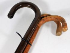 A polished walking stick twinned with two others