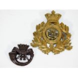 A brass DCLI cap badge & one other