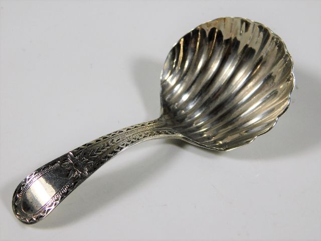 A Georgian silver caddy spoon with bright cut deco