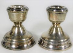 A pair of short silver candlesticks