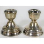 A pair of short silver candlesticks