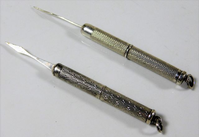 Two silver cigar piercers