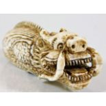 A late 19thC. Oriental carved ivory dragon netsuke