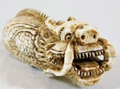 A late 19thC. Oriental carved ivory dragon netsuke