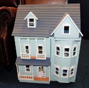 A 20thC. dolls house, 27in high x 21in wide