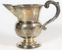 A chased silver footed jug