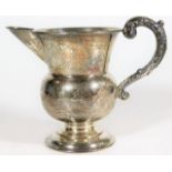 A chased silver footed jug