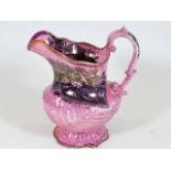 A 19thC. pink lustreware jug with images depicting