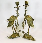 A pair of Chinese brass candlesticks depicting cra
