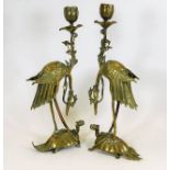 A pair of Chinese brass candlesticks depicting cra