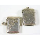 Two small silver vestas both with chased decor