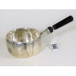 A decorative French silver brandy warming pan with