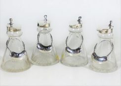 A set of four matching antique hallmarked silver topped whisky noggins with silver labels, three ass
