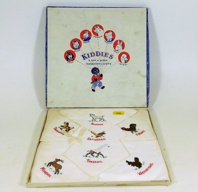 A boxed set of child's silk handkerchiefs with day