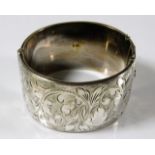A large silver bangle with chased decor
