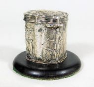 A small white metal peppermint box with embossed figurative decor mounted