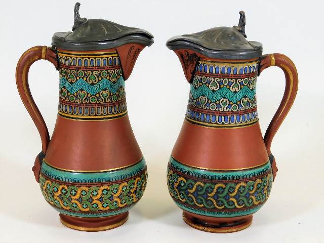 A pair of Prattware terracotta jugs with pewter li