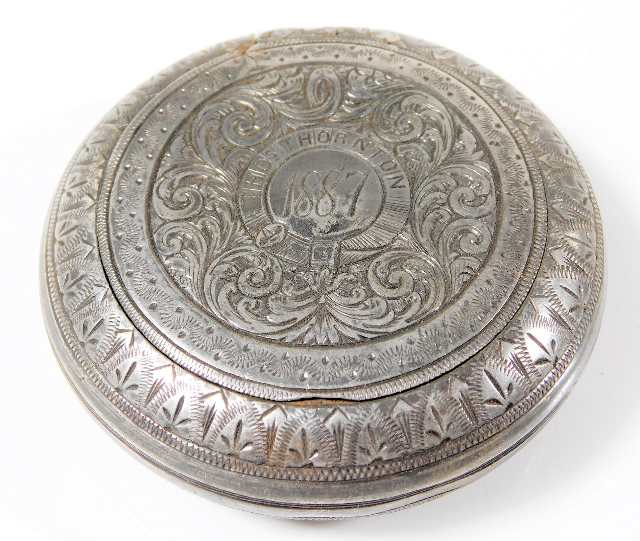 A chased white metal snuff box inscribed Thomas Th