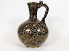 A Jackfield style jug with gilding & enamelled jew