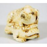 A c.1900 Japanese carved ivory of piglet riding on