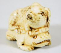 A c.1900 Japanese carved ivory of piglet riding on