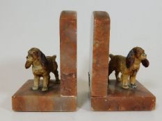 A pair of 1930's marble bookends with cold painted
