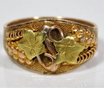 A Montana Gold two tone ring with grape & vine dec