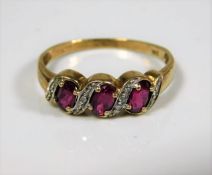 A 9ct gold ring set with pink stones & small diamo