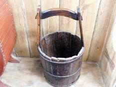 A rustic reproduction coopered well bucket