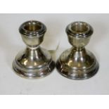 A pair of small stubby silver candleholders 2.75in